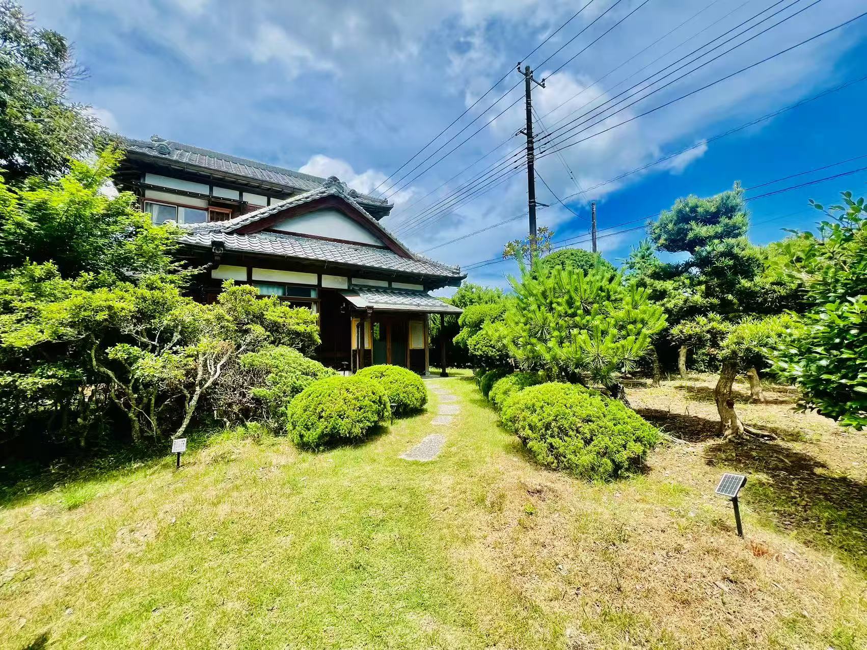 庭木に囲まれた古民家 松の外観
